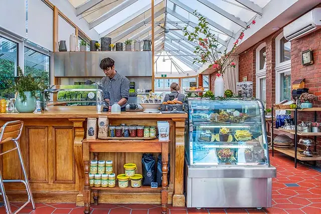 The café counter and glass roof inside Cygnet Old Bank’s conservatory.